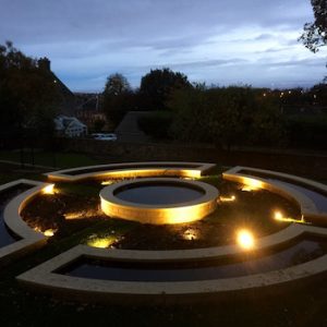 Garden Lighting - circular pond structure lit up at dusk