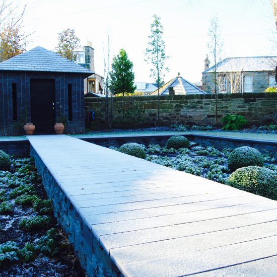 Slate garden building and boardwalk in winter, in Edinburgh garden built by Water Gems, designed by Carolyn Grohmann