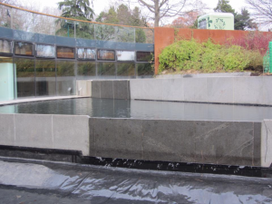 Water flowing over the weir at the rebuilt pools at John Hope Gateway, Edinburgh