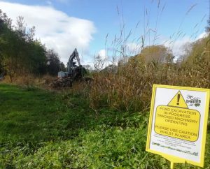 Callander Froglife site - yellow warning signpost. Mechanical digger in the background.