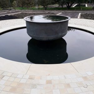 Water feature with metal cheese vat centrepiece
